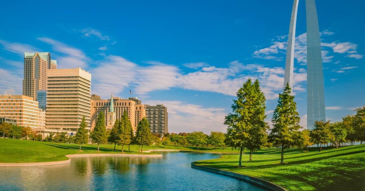 A river cutting through Gateway National Park in Missouri. The city is to one side of the river and the Arch is to the other.