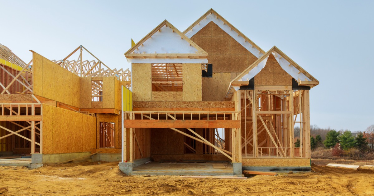 A house that is in the middle of being constructed. The frame and foundation has been set up already.