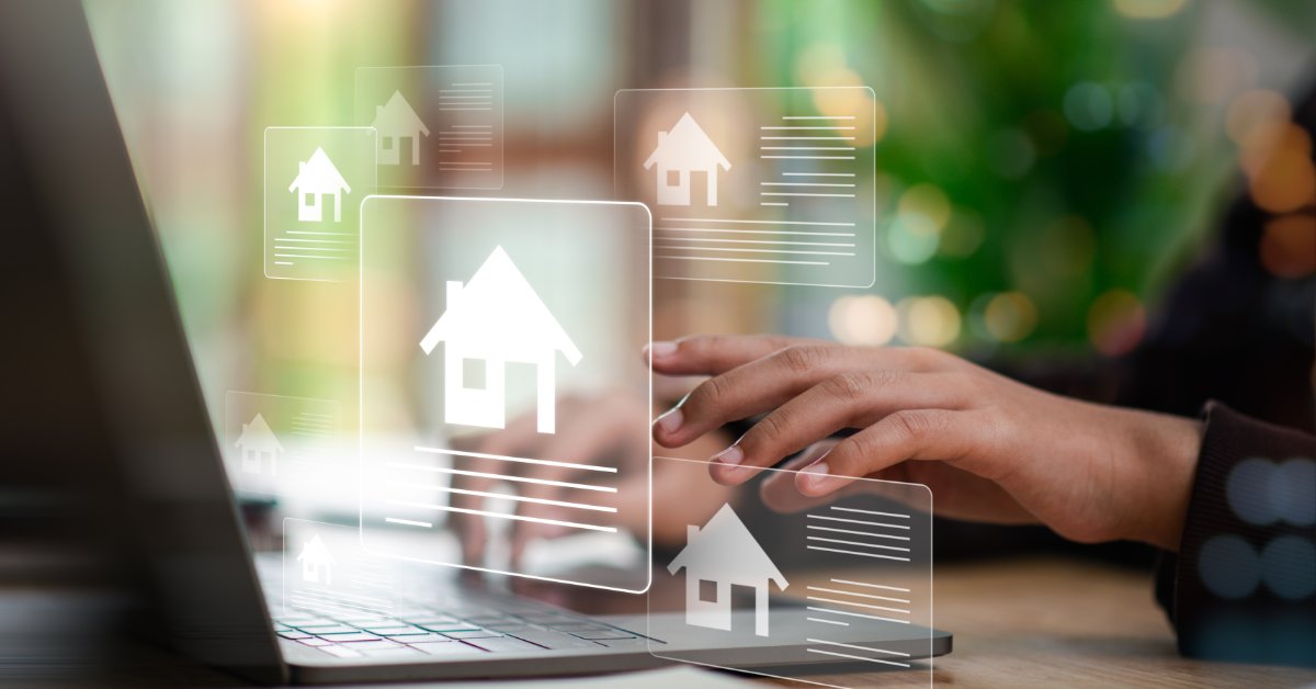 A real estate agent using a laptop to compare house prices. Small images of houses are floating above the keyboard.