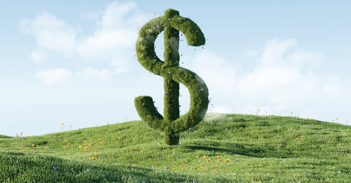 A large topiary dollar sign towers over a small grassy hill dotted with wildflowers. The sky is pale blue above.